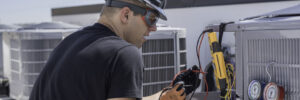 HVAC employee servicing air conditioning units